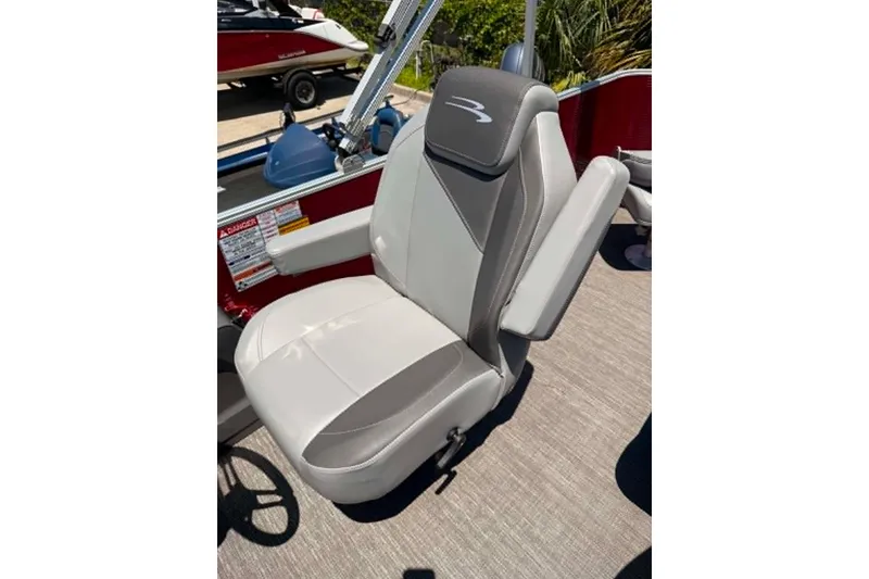 Slide: The Image of 2024 Bennington SV 20 boat seat, gray and white upholstery, armrests, outdoor setting. - 5