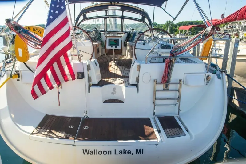Slide: The Image of 2007 Beneteau Oceanis Clipper 523 sailboat docked, displaying American flag, Walloon Lake, MI. - 5