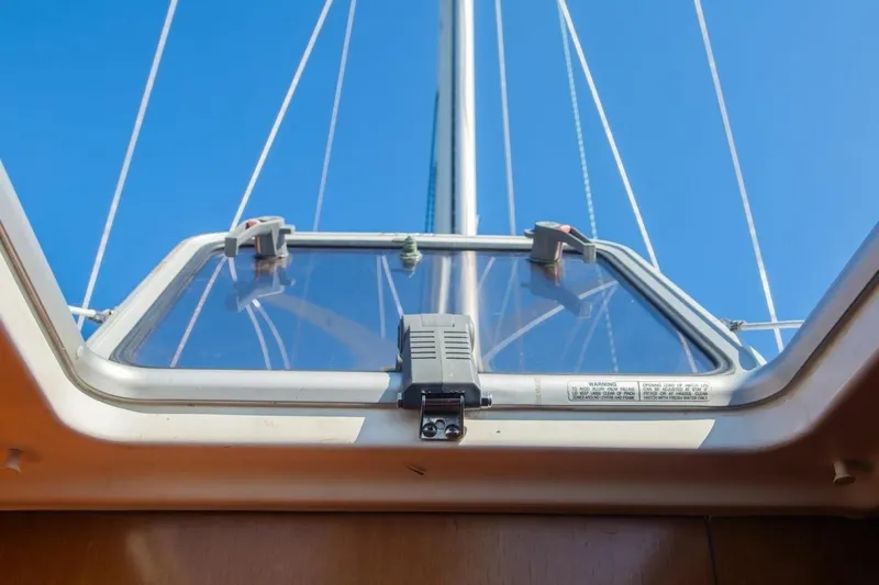 Slide: The Image of Hatch view from 2007 Beneteau Oceanis Clipper 523 sailboat, showcasing mast and blue sky. - 8