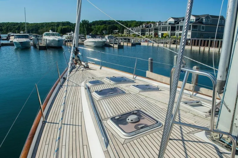 Slide: The Image of 2007 Beneteau Oceanis Clipper 523 yacht docked at a marina, showcasing its sleek deck design. - 4