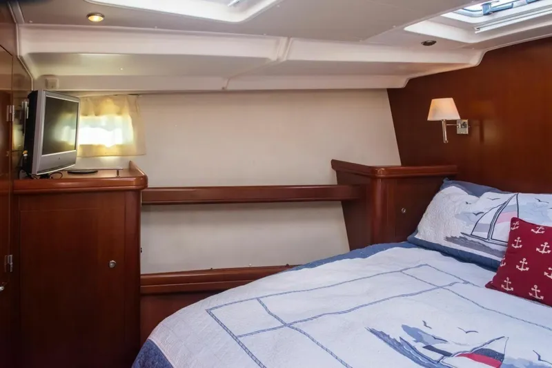 Slide: The Image of Cozy cabin interior of 2007 Beneteau Oceanis Clipper 523 with nautical-themed bedding. - 20