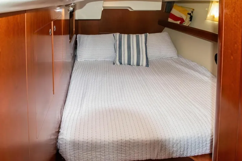 Slide: The Image of Cozy cabin interior of 2007 Beneteau Oceanis Clipper 523 with striped pillow and wooden finish. - 22