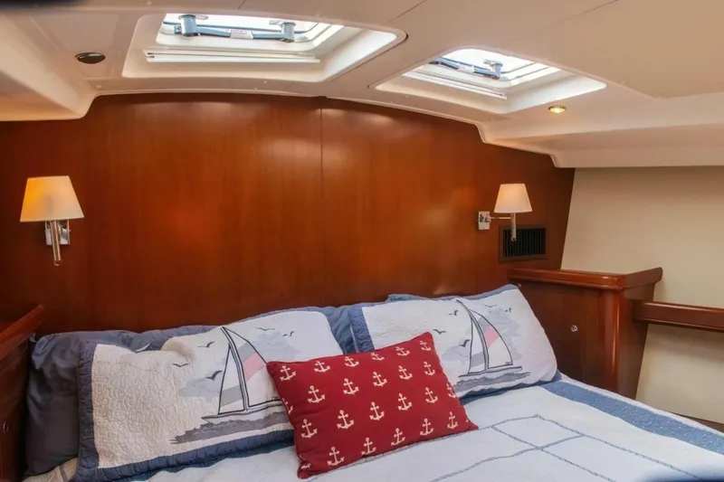 Slide: The Image of Cozy cabin interior of 2007 Beneteau Oceanis Clipper 523 with nautical-themed bedding. - 21