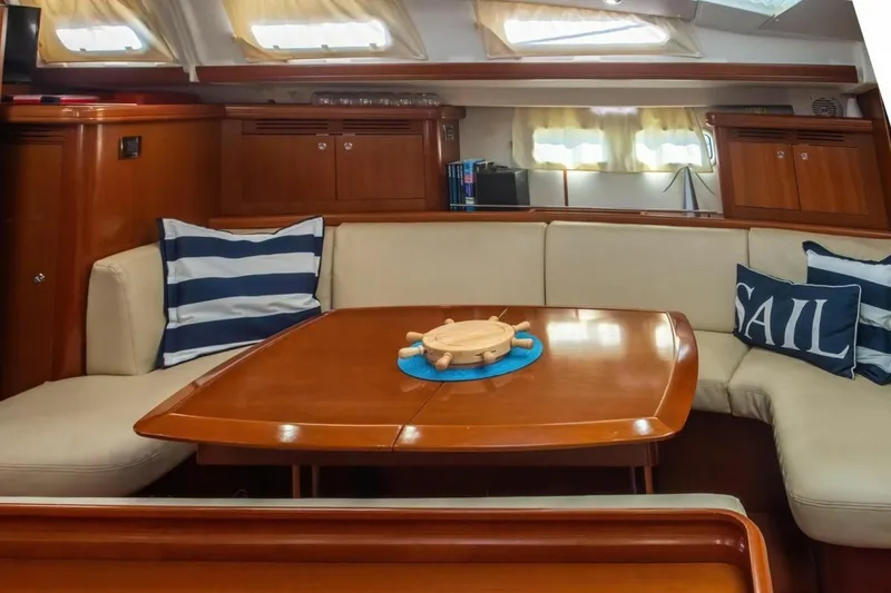 Slide: The Image of Interior of 2007 Beneteau Oceanis Clipper 523 yacht with cozy seating and nautical decor. - 13