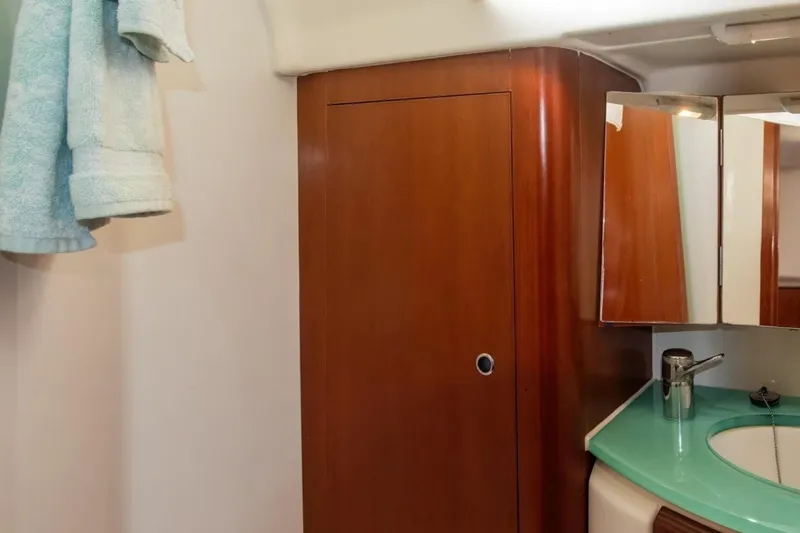 Slide: The Image of Bathroom interior of 2007 Beneteau Oceanis Clipper 523 yacht with wooden cabinet and mirror. - 23
