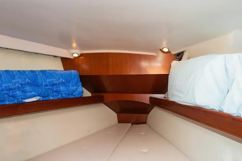 Slide: The Image of Interior cabin of 2007 Beneteau Oceanis Clipper 523 with cozy bedding and wooden accents. - 28