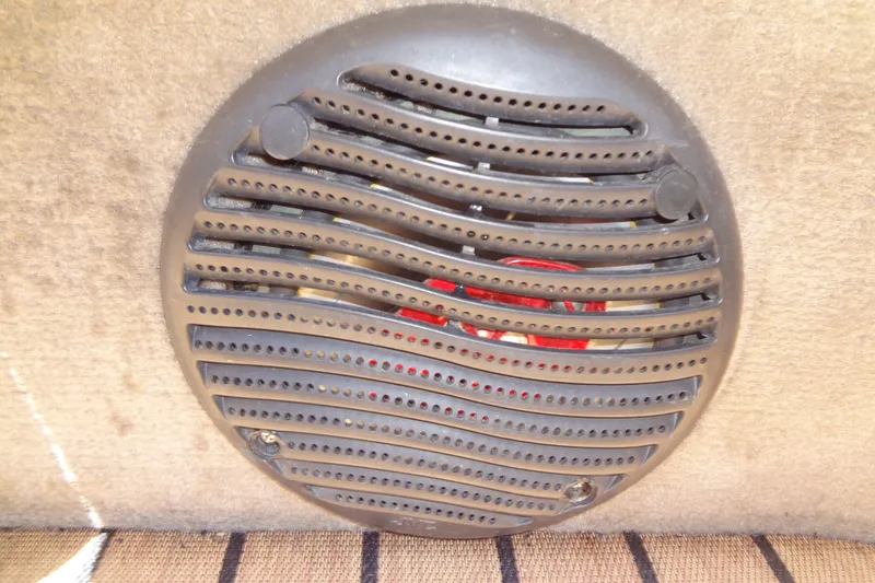 Slide: The Image of Round speaker grille in a 2000 Malibu Sunsetter VLX boat interior. - 25