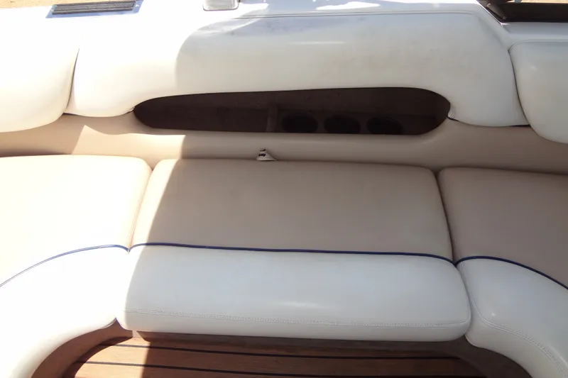 Slide: The Image of Interior seating of a 2000 Malibu Sunsetter VLX boat with white upholstery. - 17