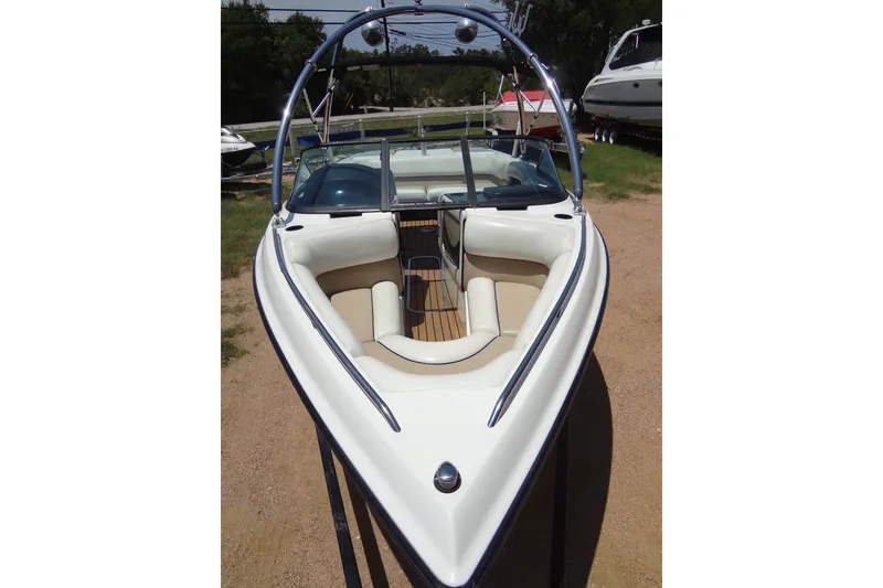 Slide: The Image of 2000 Malibu Sunsetter VLX boat with sleek design and spacious seating. - 9