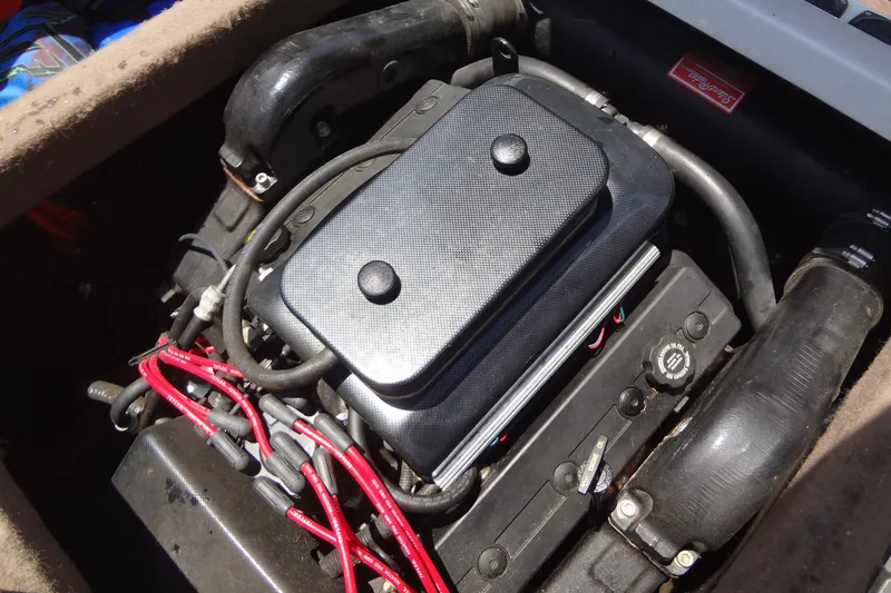 Slide: The Image of Engine of a 2000 Malibu Sunsetter VLX boat with visible wiring and components. - 30