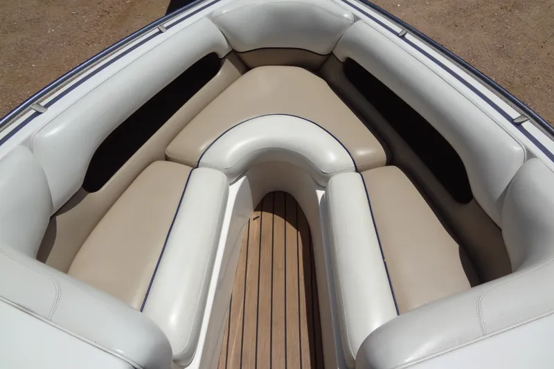 Slide: The Image of Interior seating of a 2000 Malibu Sunsetter VLX boat with beige and white upholstery. - 11