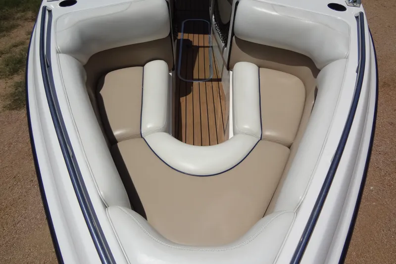 Slide: The Image of 2000 Malibu Sunsetter VLX boat interior with beige and white cushioned seating. - 10