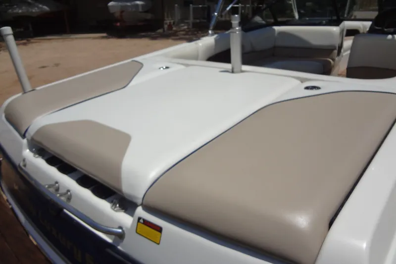 Slide: The Image of 2000 Malibu Sunsetter VLX boat interior with beige and white seating. - 13