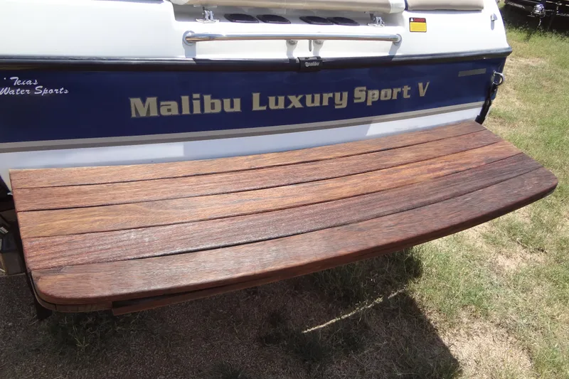 Slide: The Image of Rear view of 2000 Malibu Sunsetter VLX boat with wooden swim platform. - 4