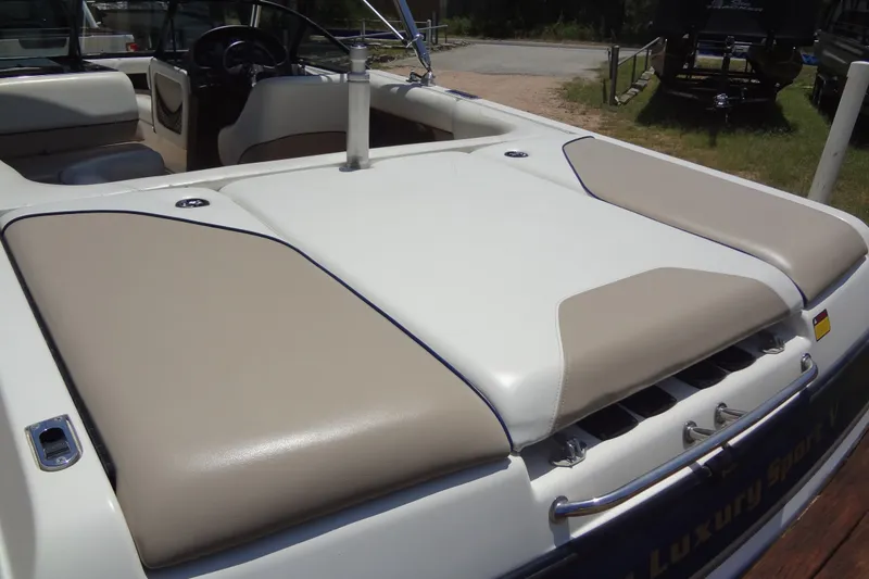 Slide: The Image of 2000 Malibu Sunsetter VLX boat interior with beige and white seating. - 12