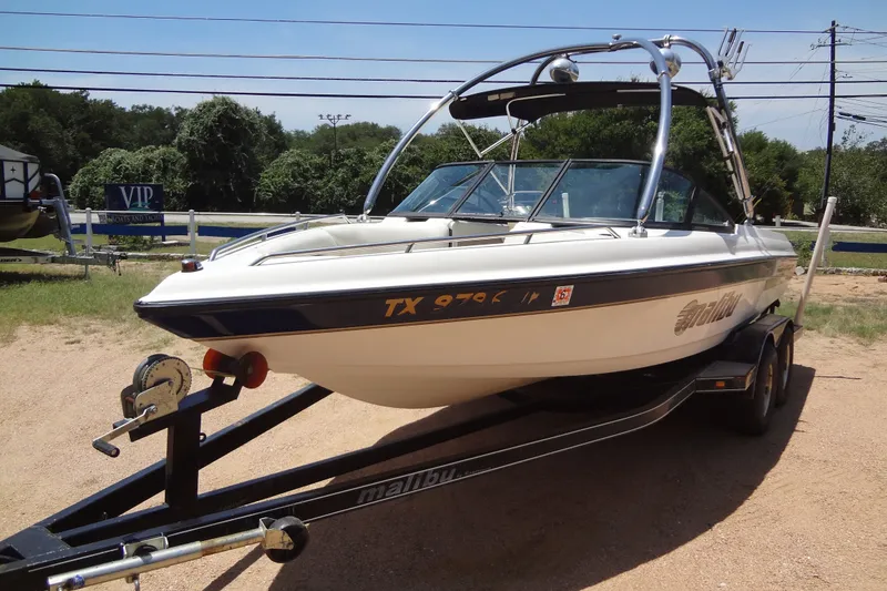 Slide: The Image of 2000 Malibu Sunsetter VLX boat on trailer, parked outdoors on a sunny day. - 8