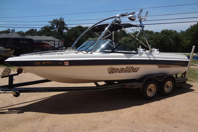 Slide: The Image of 2000 Malibu Sunsetter VLX boat on trailer, parked outdoors on a sunny day. - 7