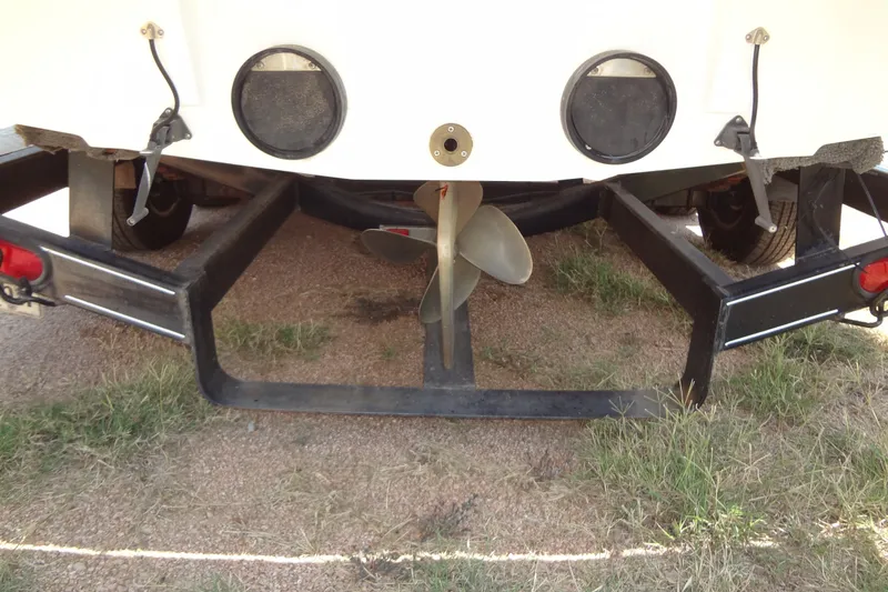 Slide: The Image of Rear view of a 2000 Malibu Sunsetter VLX boat on a trailer, showing the propeller. - 31
