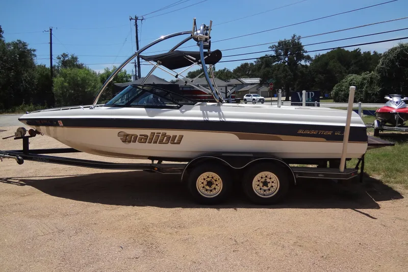 Slide: The Image of 2000 Malibu Sunsetter VLX boat on trailer, parked outdoors on a sunny day. - 6