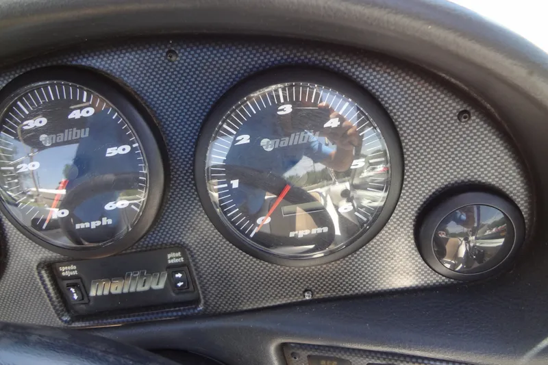Slide: The Image of Dashboard of a 2000 Malibu Sunsetter VLX boat showing speedometer and tachometer. - 22