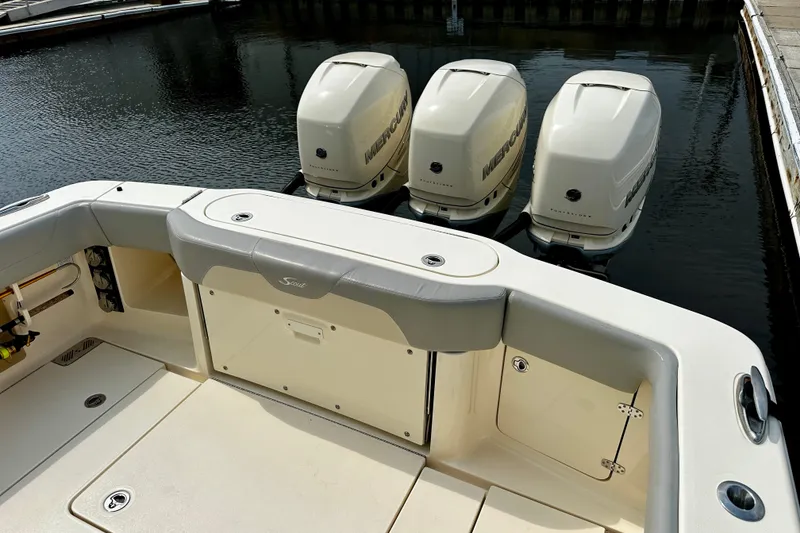Slide: The Image of 2019 Scout 355 LXF boat with triple Mercury outboard engines at dock. - 15