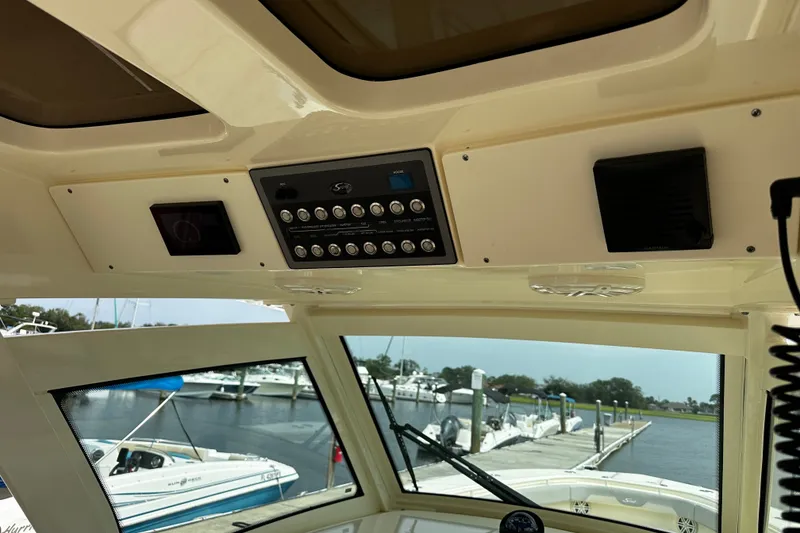 Slide: The Image of Interior view of a 2019 Scout 355 LXF boat dashboard with control panel. - 11