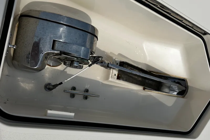 Slide: The Image of Anchor compartment of 2019 Scout 355 LXF boat, featuring a metal winch system. - 29
