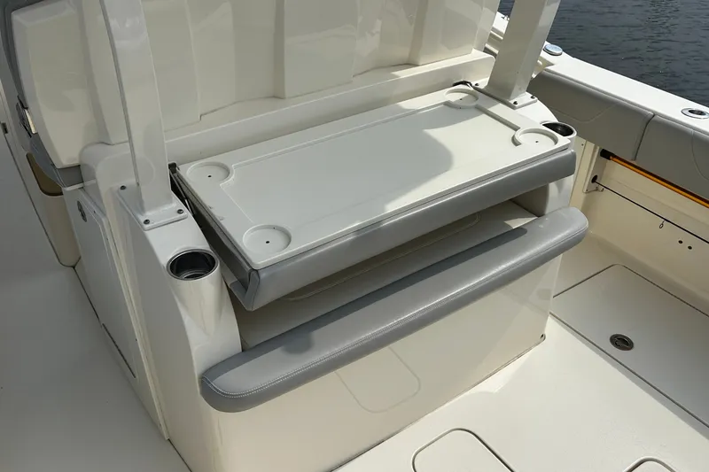 Slide: The Image of 2019 Scout 355 LXF boat interior with foldable seating and cup holders. - 13