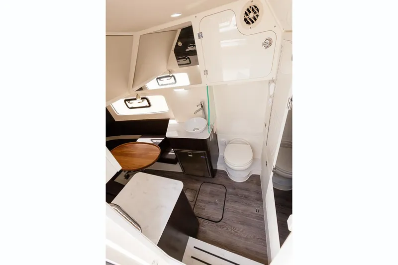 Slide: The Image of Manufacturer Provided Image: 2019 Scout 355 LXF boat interior with modern amenities, including a sink, toilet, and seating area. - 22