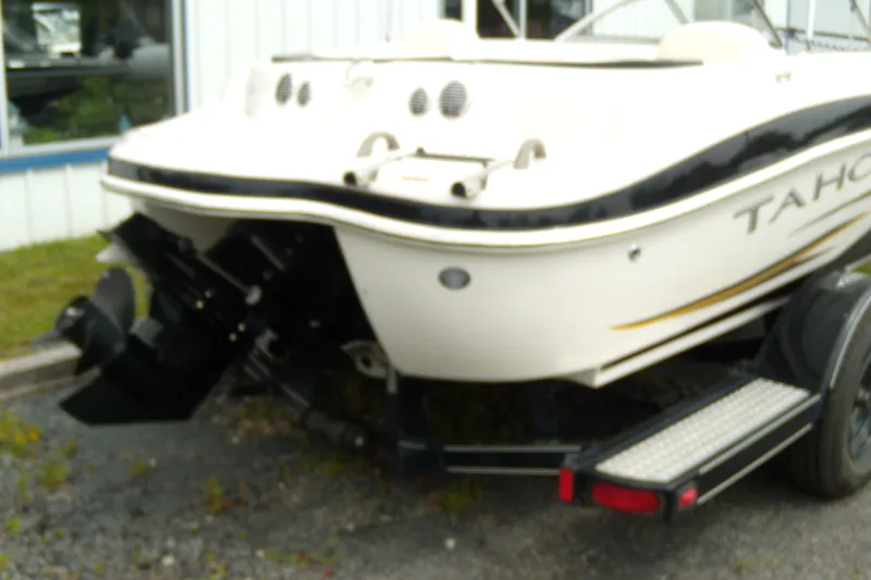 Slide: The Image of 2008 Tahoe Q4 SF boat on trailer, rear view, parked outdoors. - 2