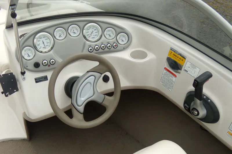 Slide: The Image of 2008 Tahoe Q4 SF boat dashboard with steering wheel and control panel. - 6