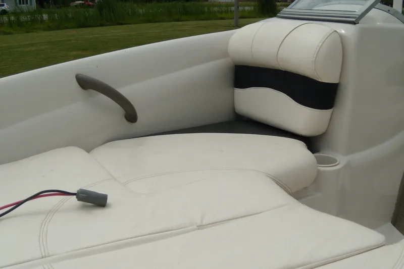 Slide: The Image of 2008 Tahoe Q4 SF boat interior with white cushioned seating and cup holder. - 4