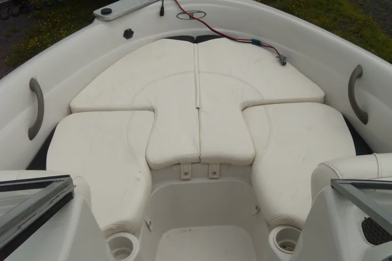 Slide: The Image of 2008 Tahoe Q4 SF boat interior with white cushioned seating and cup holders. - 8