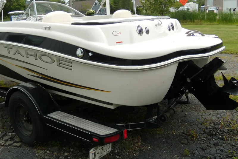 Slide: The Image of 2008 Tahoe Q4 SF boat on trailer, rear view, parked on gravel. - 3