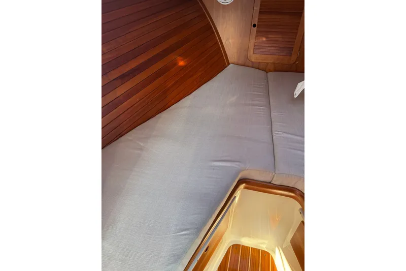 Slide: The Image of Interior cabin of 2000 Hinckley Picnic Boat 36 Classic with wooden paneling and cushioned seating. - 14