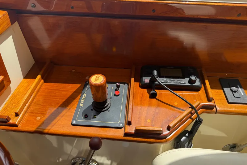 Slide: The Image of Control panel of a 2000 Hinckley Picnic Boat 36 Classic with joystick and radio. - 13