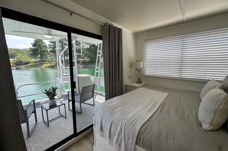 Slide: The Image of Cozy bedroom in a 1993 Sumerset 14x65 houseboat with lake view and outdoor seating. - 9