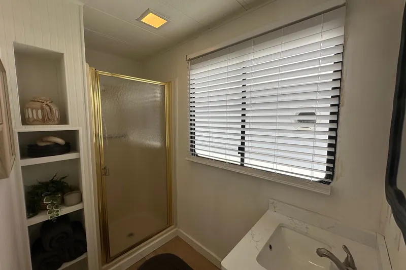 Slide: The Image of Bathroom interior of 1993 Sumerset 14x65 houseboat with shower, sink, and window blinds. - 11