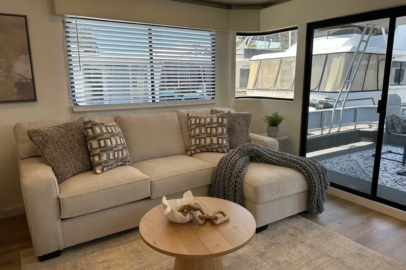 Slide: The Image of Cozy living area in a 1993 Sumerset 14x65 houseboat with modern decor and large windows. - 4