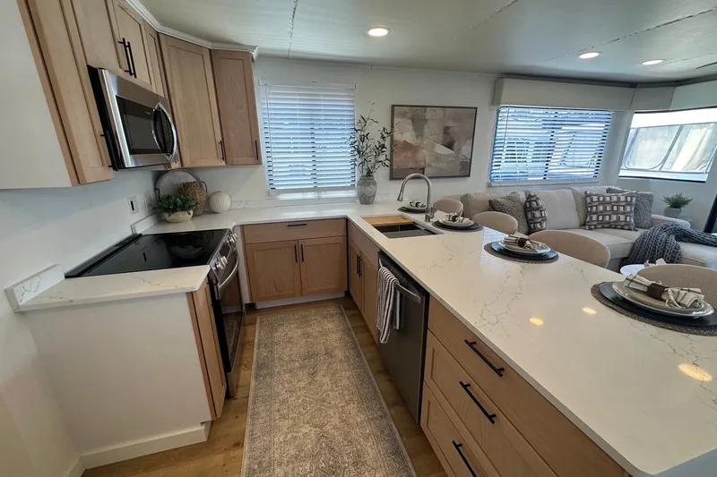 Slide: The Image of Modern kitchen interior in a 1993 Sumerset 14x65 houseboat, featuring sleek countertops and cozy seating. - 6