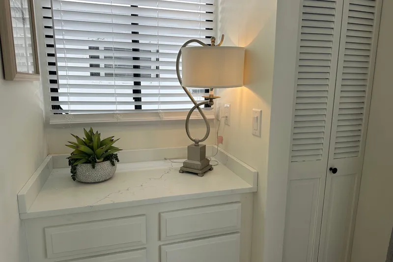 Slide: The Image of Cozy corner with elegant lamp, potted plant, and white cabinetry in a Sumerset 14x65, 1993 model. - 10