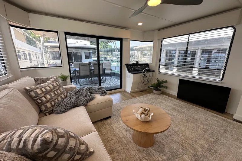Slide: The Image of Cozy living area in a 1993 Sumerset 14x65 houseboat with modern decor and large windows. - 2