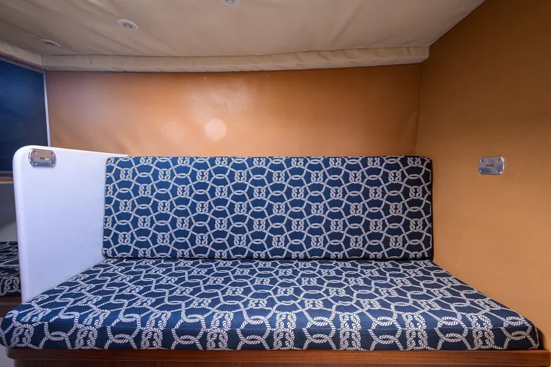 Slide: The Image of Interior seating of 2014 Release Boatworks 46 with patterned blue cushions. - 49