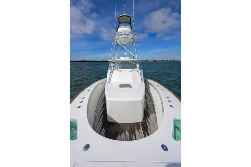 Slide: The Image of 2014 Release Boatworks 46 on water, showcasing sleek design and spacious deck under blue sky. - 15