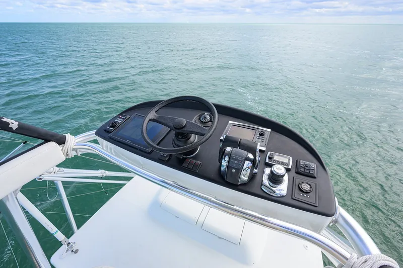 Slide: The Image of Helm of 2014 Release Boatworks 46 overlooking calm ocean waters. - 41