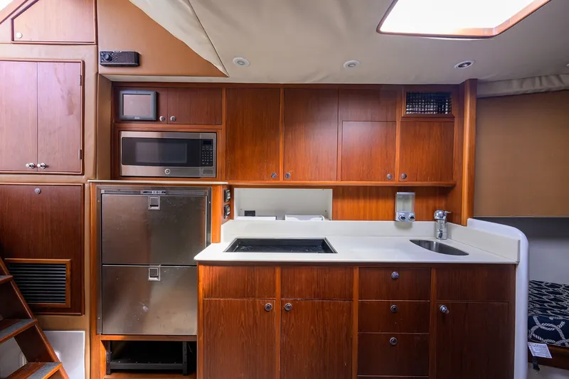 Slide: The Image of Luxurious 2014 Release Boatworks 46 interior kitchen with wood cabinetry and modern appliances. - 48