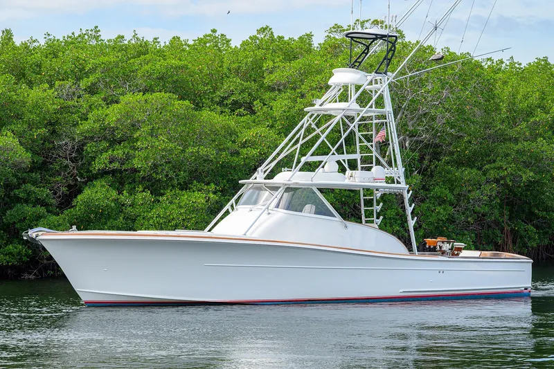 Slide: The Image of 2014 Release Boatworks 46 yacht on calm water, surrounded by lush greenery. - 8
