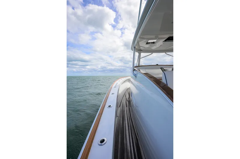 Slide: The Image of Side view of a 2014 Release Boatworks 46 yacht on open water under cloudy skies. - 16