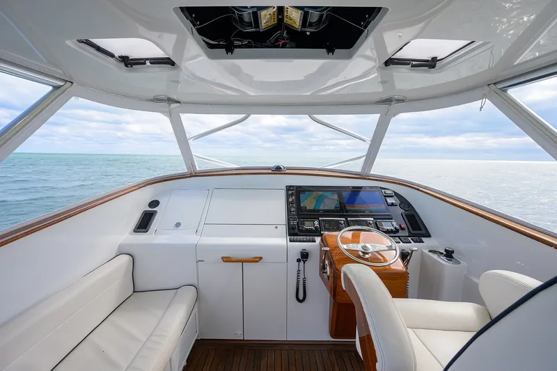 Slide: The Image of Helm of 2014 Release Boatworks 46, featuring modern navigation equipment and ocean view. - 32