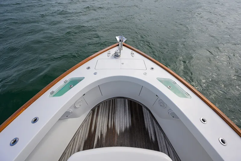 Slide: The Image of Bow view of 2014 Release Boatworks 46, featuring sleek design and teak decking. - 13